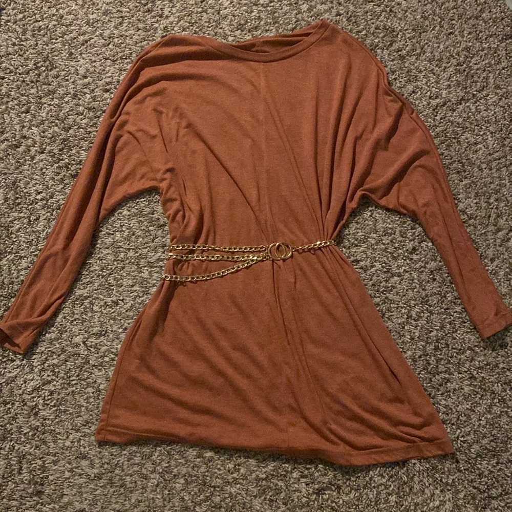 It’s a cute brown gold ish dress with an adjustable gold chain